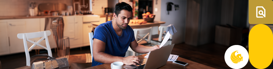 Holding a page while looking into a computer screen answering some FAQs