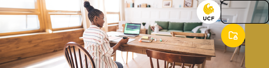 sitting on a chair in front of the computer screen with a marker in her hand and learning for the AWS Certified Security Exam